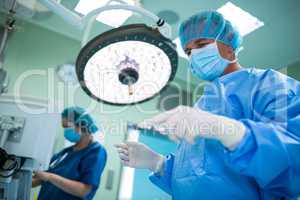 Surgeon holding surgical tool in operation room