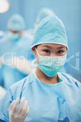 Portrait of female surgeon preparing for operation in operation