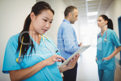 Nurse using digital tablet in hospital