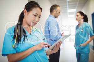 Nurse using digital tablet in hospital