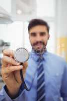 Portrait of smiling doctor holding stethoscope