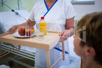 Nurse serving a breakfast to patient