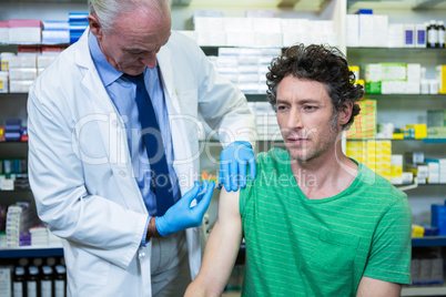 Pharmacist giving injection to patient