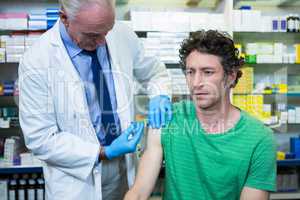 Pharmacist giving injection to patient