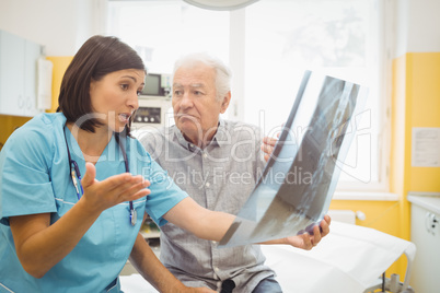 Female doctor discussing x-ray with patient