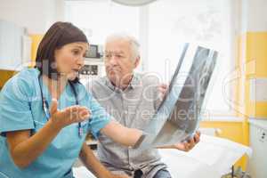 Female doctor discussing x-ray with patient