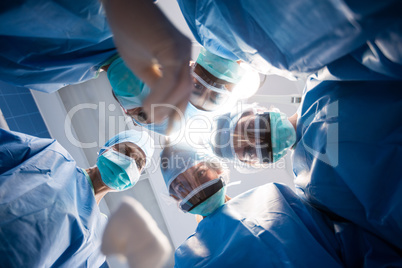 Group of surgeons looking at camera in operation room