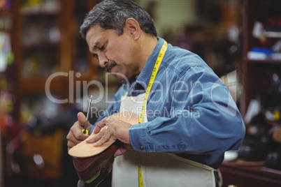 Shoemaker repairing a shoe