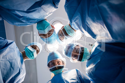 Group of surgeons looking at camera in operation room