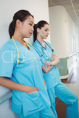 Sad nurse leaning against the wall