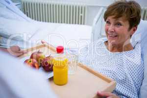 Nurse serving a breakfast to patient