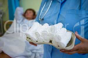 Nurse holding a tray of bandage