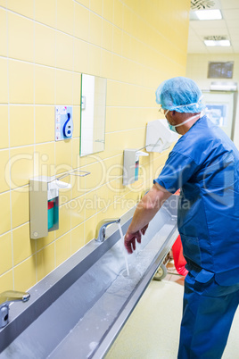 Surgeon washing their hands at washbasin