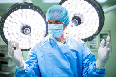 Surgeon preparing for operation in operation room