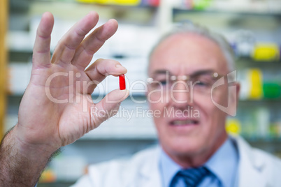 Pharmacist checking a capsule