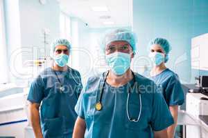 Portrait of surgeon and nurses standing in hospital
