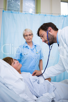 Doctors examining a patient with a stethoscope