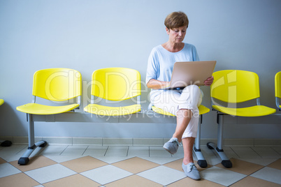 Patient sitting with report in a waiting room