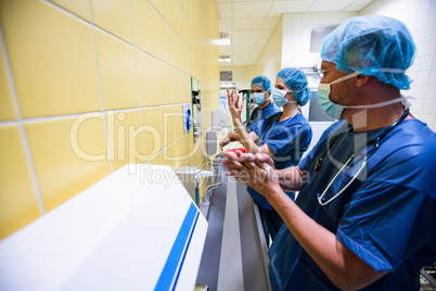 Group of surgeons washing their hands