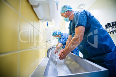 Group of surgeons washing their hands at washbasin