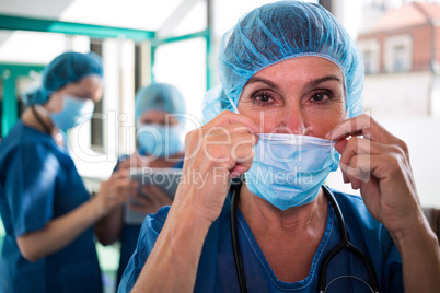 Portrait of surgeon wearing surgical mask in surgical room