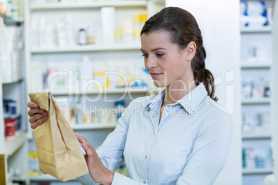 Pharmacist looking at medicine package