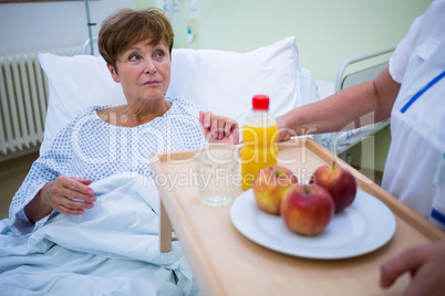 Nurse serving a breakfast to patient