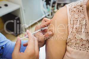 Close-up of male doctor giving an injection to a patient