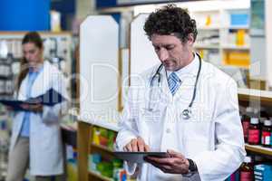 Pharmacist using digital tablet