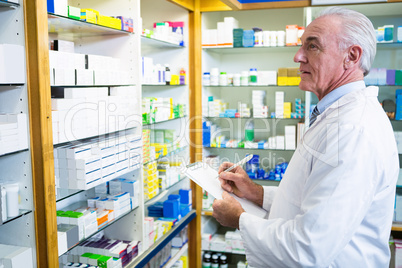 Pharmacist writing on clipboard