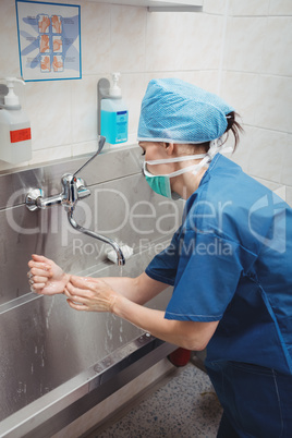 Female surgeon washing her hands