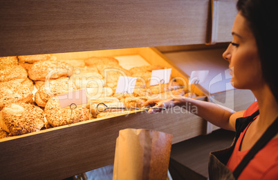 Female baker packing sweet food