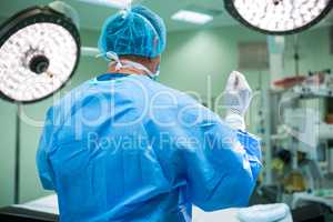 Rear view of surgeon standing in operation room