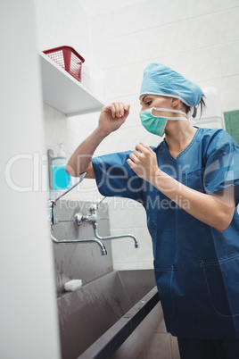 Female surgeon washing hands prior to operation using correct te