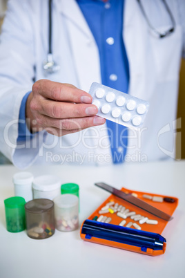 Pharmacist holding a packet of tablets