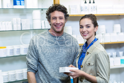 Couple holding a medicine box in pharmacy