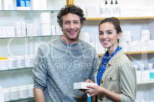 Couple holding a medicine box in pharmacy