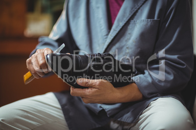 Shoemaker repairing a shoe