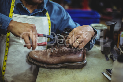 Shoemaker repairing a shoe