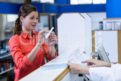 Pharmacist assisting medicine to customer