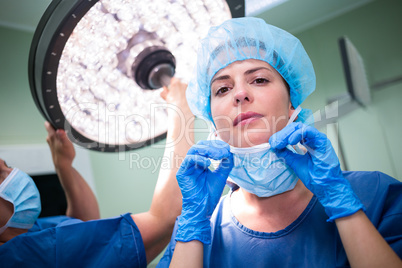 Female surgeon wearing surgical mask