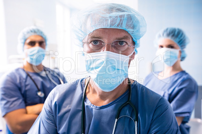 Surgeon and nurses standing in hospital