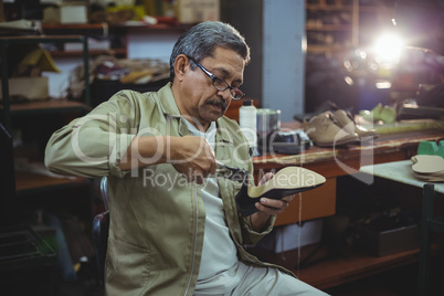 Shoemaker repairing a high heel