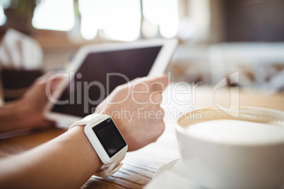 Hands of woman using digital tablet