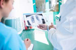 Close-up of doctor and nurses examining an x-ray