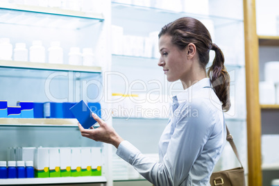 Customer checking a box of medicine