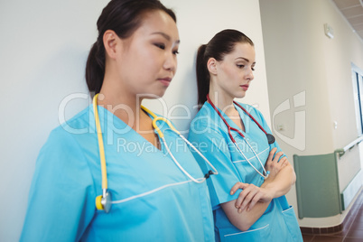 Sad nurse leaning against the wall