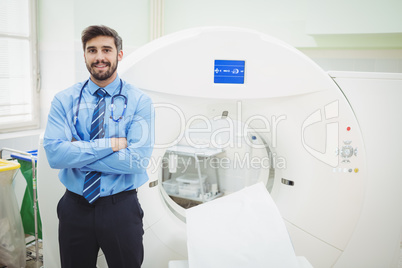 Portrait of doctor standing near mri scanner