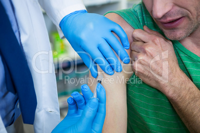 Pharmacist giving injection to patient