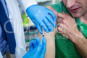 Pharmacist giving injection to patient